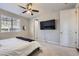 Serene main bedroom with soft carpet, a ceiling fan, and a mounted television at 18187 E 99Th Ave, Commerce City, CO 80022