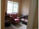 Cozy bedroom featuring a window with sunlight and two chairs at 19692 E Mann Creek Dr # D, Parker, CO 80134