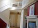 A spacious entryway leads to the upper level, with views of the staircase and fireplace at 19692 E Mann Creek Dr # D, Parker, CO 80134