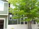 Green exterior of home surrounded by mature landscaping and a white fence at 19692 E Mann Creek Dr # D, Parker, CO 80134