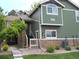 Charming two-story home with stone accents, landscaped yard, and well-maintained green exterior at 19692 E Mann Creek Dr # D, Parker, CO 80134