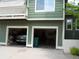 Two-car garage with open doors; showing ample storage space with exterior balcony above at 19692 E Mann Creek Dr # D, Parker, CO 80134