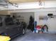 Large garage with lots of storage space and a car parked inside at 19692 E Mann Creek Dr # D, Parker, CO 80134