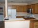 A kitchen featuring wooden cabinets, white appliances, and ample counter space at 19692 E Mann Creek Dr # D, Parker, CO 80134