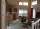 Bright, open-concept living room with a fireplace, high ceilings, and dining area at 19692 E Mann Creek Dr # D, Parker, CO 80134