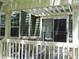 Back patio with white fencing, a pergola, and sliding glass doors leading indoors at 19692 E Mann Creek Dr # D, Parker, CO 80134