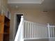View of an upper level hallway from the top of a staircase with white railings at 19692 E Mann Creek Dr # D, Parker, CO 80134