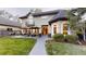 Spacious backyard with a patio, outdoor seating, and manicured lawn at 1160 Monaco Pkwy, Denver, CO 80220