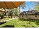 A landscaped backyard is enhanced by a concrete walkway and perimeter garden at 1160 Monaco Pkwy, Denver, CO 80220