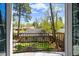 Charming balcony view of the backyard, with a lush green lawn and mature trees at 1160 Monaco Pkwy, Denver, CO 80220
