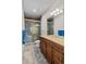 Bathroom featuring a glass-enclosed shower and vanity with a granite countertop at 1160 Monaco Pkwy, Denver, CO 80220