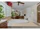 An elegant bathroom featuring a soaking tub, large window and a separate vanity area at 1160 Monaco Pkwy, Denver, CO 80220
