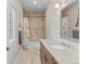 Cozy bathroom features a granite countertop vanity, shower over tub, and tiled walls at 1160 Monaco Pkwy, Denver, CO 80220