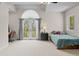 Bright bedroom featuring a tray ceiling, a bed, and glass doors to the exterior at 1160 Monaco Pkwy, Denver, CO 80220