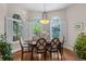 Bright breakfast nook with arched windows, white shutters, and a charming chandelier at 1160 Monaco Pkwy, Denver, CO 80220