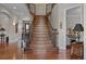 Grand foyer featuring a wood staircase with rod iron railings at 1160 Monaco Pkwy, Denver, CO 80220