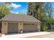 A two car garage features stone accents, sconce lighting, and decorative door windows at 1160 Monaco Pkwy, Denver, CO 80220