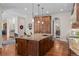 Gourmet kitchen with a large island, custom cabinetry, and hardwood flooring at 1160 Monaco Pkwy, Denver, CO 80220