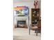 Cozy living room features a fireplace with a TV above it and a display cabinet to the side at 1160 Monaco Pkwy, Denver, CO 80220