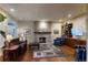 Cozy living room with stone fireplace, hardwood floors and comfortable seating at 1160 Monaco Pkwy, Denver, CO 80220