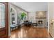 Bright living room with hardwood floors, stone fireplace, and large windows with shutters at 1160 Monaco Pkwy, Denver, CO 80220