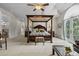 Spacious main bedroom with a canopy bed, sitting area and french doors at 1160 Monaco Pkwy, Denver, CO 80220