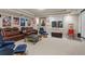 Basement media room with comfortable seating, home theater projector, and movie posters at 1160 Monaco Pkwy, Denver, CO 80220