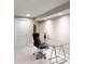 Bright office featuring a modern glass desk, comfortable chair, and neutral décor, ideal for a productive workspace at 1160 Monaco Pkwy, Denver, CO 80220