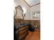 Elegant powder room featuring a marble vanity, decorative mirror, and stylish fixtures at 1160 Monaco Pkwy, Denver, CO 80220