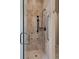 Modern shower with stone and glass features a convenient grab bar and sleek design at 1160 Monaco Pkwy, Denver, CO 80220