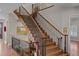 Grand staircase with hardwood steps, wrought iron balusters, and custom railings at 1160 Monaco Pkwy, Denver, CO 80220