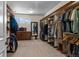 Spacious walk-in closet with custom wood shelving and a full-length mirror at 1160 Monaco Pkwy, Denver, CO 80220