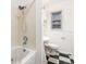 Cozy bathroom with tub and black and white tile floor at 5661 E Amherst Ave, Denver, CO 80222