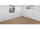 Cozy bedroom with neutral carpeting, white walls, and natural light from two windows at 5661 E Amherst Ave, Denver, CO 80222