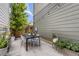 Cozy backyard patio with a dining table and chairs, surrounded by lush plants and greenery at 6058 Beeler Ct, Denver, CO 80238