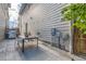 Backyard patio featuring a modern dining set and grill, perfect for outdoor dining and entertaining at 6058 Beeler Ct, Denver, CO 80238