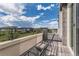 Relaxing outdoor balcony with seating area and neighborhood views under a cloudy blue sky at 6058 Beeler Ct, Denver, CO 80238