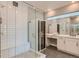 Modern bathroom with a glass-enclosed shower, vanity area, and sleek, minimalist design at 6058 Beeler Ct, Denver, CO 80238