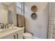 Stylish bathroom featuring modern fixtures, a white vanity, and decorative wall art at 6058 Beeler Ct, Denver, CO 80238