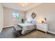 Cozy bedroom with neutral tones, a comfortable bed, and ample natural light from a window at 6058 Beeler Ct, Denver, CO 80238