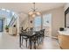 Modern dining room featuring a stylish light fixture and large windows at 6058 Beeler Ct, Denver, CO 80238