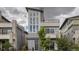 Modern gray two-story home with multi-pane windows, balcony, and manicured landscaping at 6058 Beeler Ct, Denver, CO 80238