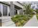 Stylish gray home featuring a brick pillar porch and expertly landscaped front garden at 6058 Beeler Ct, Denver, CO 80238