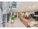 Open concept living room with hardwood floors, a staircase, and modern decor at 6058 Beeler Ct, Denver, CO 80238