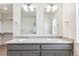 Double sinks sit below twin mirrors in this ample bathroom at 28610 E 8Th Pl, Watkins, CO 80137