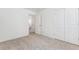 This bedroom offers neutral carpeting, white walls, and double doors for storage at 28610 E 8Th Pl, Watkins, CO 80137