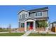 Charming two-story home with a red front door and well-manicured lawn at 28610 E 8Th Pl, Watkins, CO 80137