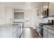 Modern kitchen featuring gray cabinets, stainless steel appliances and granite countertops at 28610 E 8Th Pl, Watkins, CO 80137