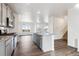 Open kitchen view with stainless appliances, granite island and wood floors at 28610 E 8Th Pl, Watkins, CO 80137