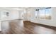 Bright living room featuring wood floors, white walls and large windows at 28610 E 8Th Pl, Watkins, CO 80137
